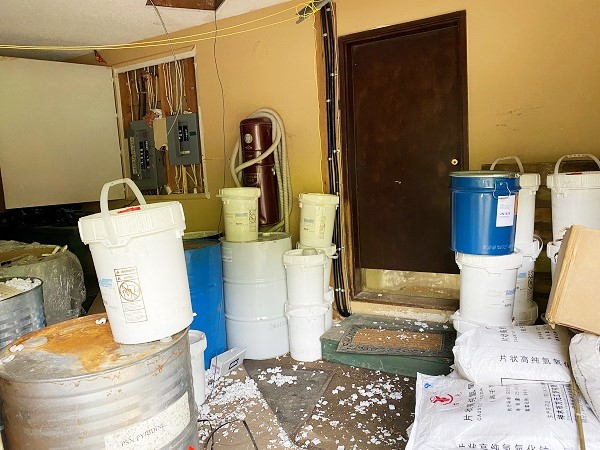 Bins of chemicals inside a garage drug lab