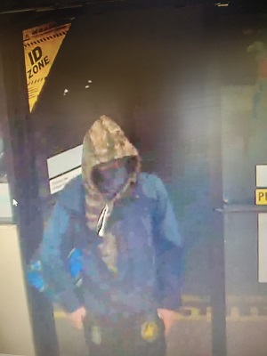 Suspect wearing mask and camo hoodie 