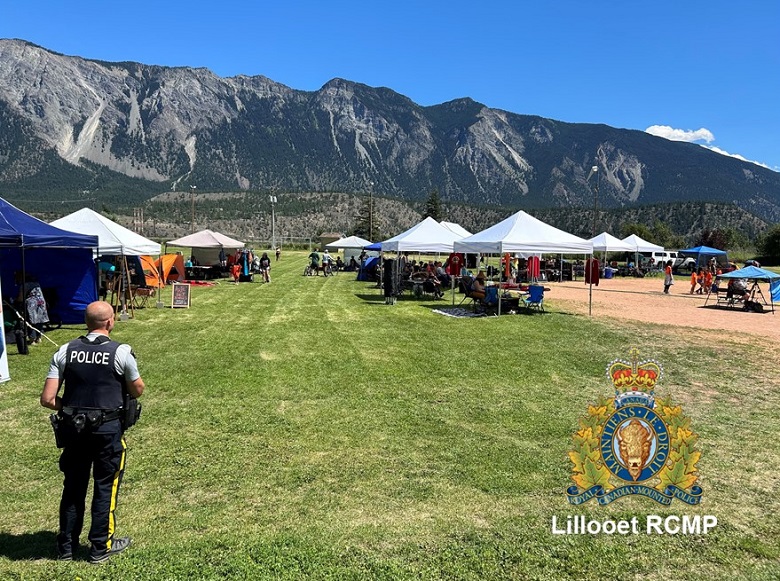 Lillooet RCMP member pictured looking out at local concert at Conway Park. 