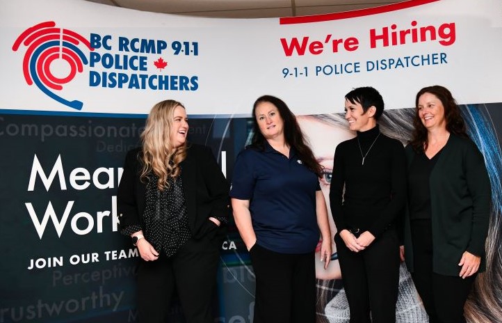 Recruiters standing in front of sign